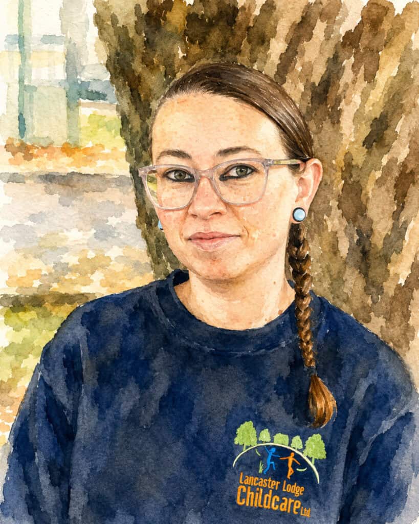 Amber Cole outdoors at Lancaster Lodge Childcare, smiling near a tree.