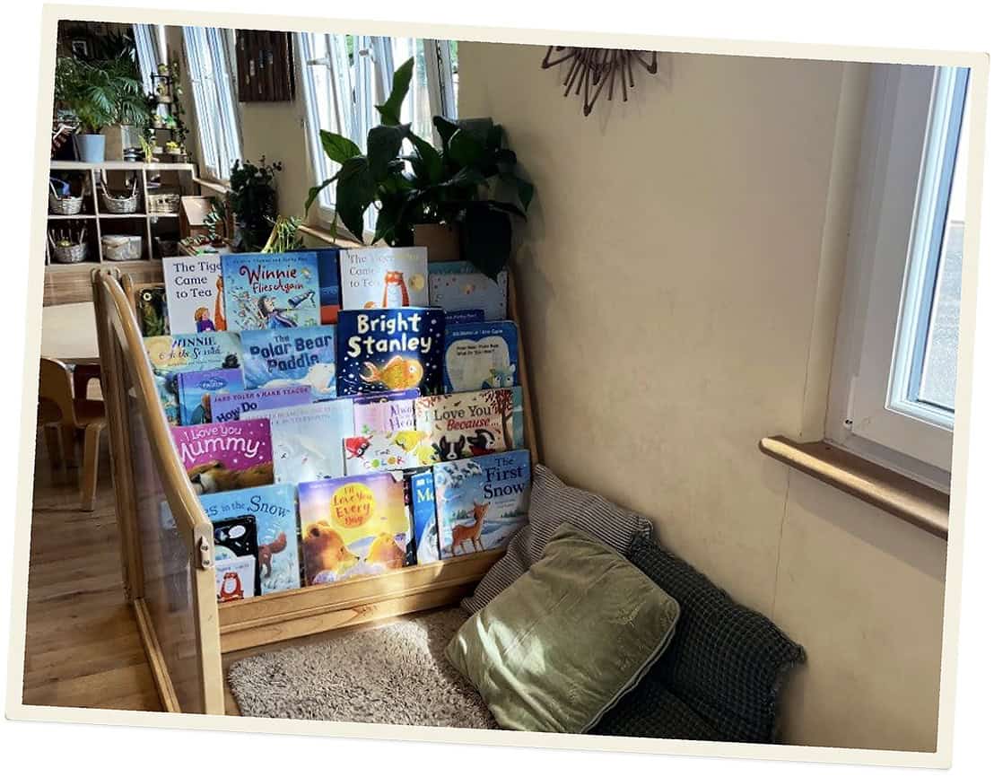 Children's books displayed in a cozy reading corner at Lancaster Lodge Childcare.
