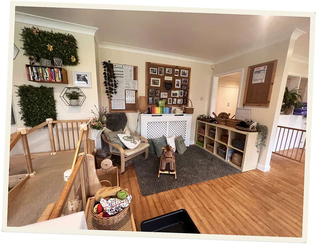 Cozy indoor childcare space with toys, seating, and educational decor.