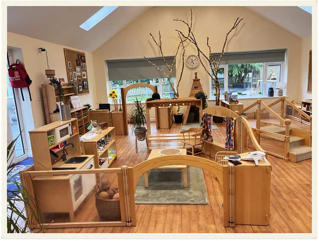 Bright indoor childcare space with wooden furniture and natural decor.